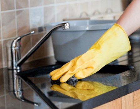 Cleaner maintaining a tidy Islington home during a regular cleaning visit